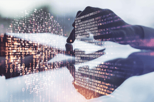 Hands typing on a laptop with digital code overlay, representing data sovereignty, cybersecurity, and data protection.
